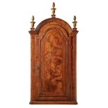 A Queen Anne walnut and feather banded domed top hanging corner cupboard, circa 1710