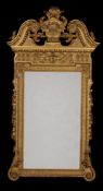 A carved giltwood wall mirror, in George II Palladian style, late 19th/early 20th century