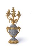 A French gilt metal mounted and polished black and white speckled granite seven light candelabrum in