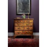 A George II figured walnut and feather banded chest of drawers, circa 1735