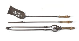 A set of three 'Egyptomania' steel and brass mounted fire tools, 19th century