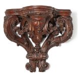 A George II carved oak wall bracket, circa 1735