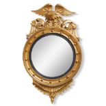 A pair of giltwood convex mirrors, in Regency style, late 19th/early 20th century