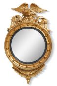 A pair of giltwood convex mirrors, in Regency style, late 19th/early 20th century