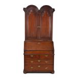 A Queen Anne 'red' walnut double dome bureau bookcase, circa 1710