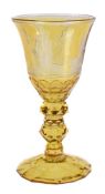 A Dutch engraved amber-flashed and faceted German glass goblet, mid 18th century