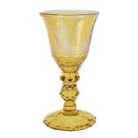 A Dutch engraved amber-flashed and faceted German glass goblet, mid 18th century