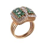 An emerald and diamond cluster ring