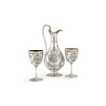 A Victorian silver claret jug and a pair of goblets by George Adams for Chawner & Co.