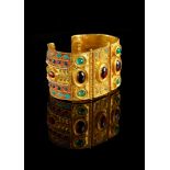 ϒ A gold coloured multi gem set bangle by Natalia Josca