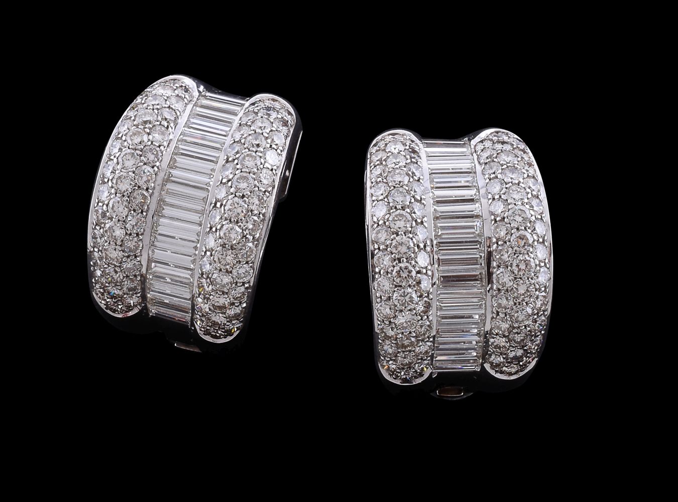 A pair of half hoop diamond earrings