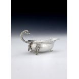 A scarce George II Scottish silver dolphin handled sauce boat by William Davie