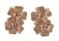 A pair of diamond and pink diamond flower head ear clips
