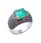 An emerald and black diamond ring