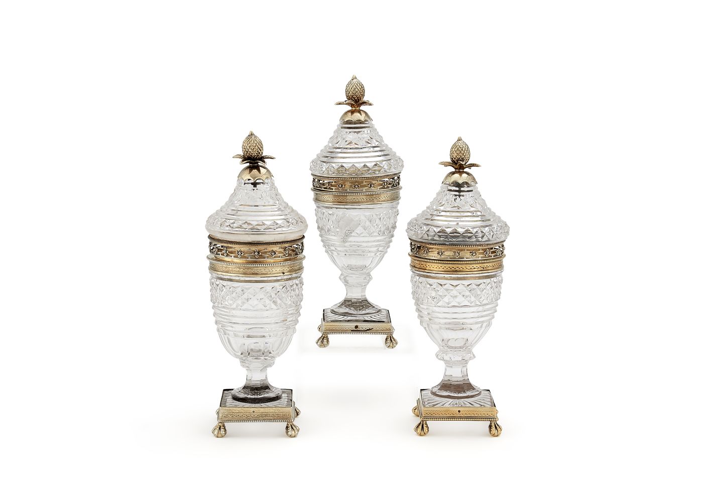 A suite of three silver gilt and cut glass sugar jars and covers