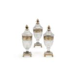 A suite of three silver gilt and cut glass sugar jars and covers