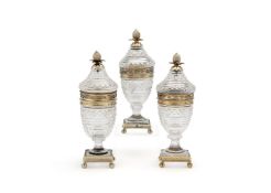 A suite of three silver gilt and cut glass sugar jars and covers