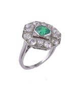 An emerald and diamond panel ring