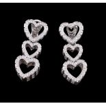 A pair of diamond triple heart ear pendants