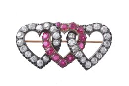 A late 19th century diamond and synthetic ruby triple heart brooch