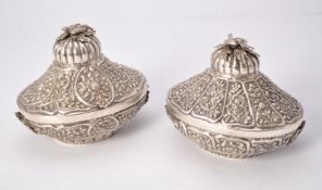 A pair of Egyptian silver coloured boxes and covers