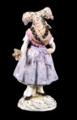 A Meissen figure of a woman wearing Alsatian folk costume