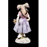 A Meissen figure of a woman wearing Alsatian folk costume