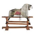 A painted wood and composition rocking horse