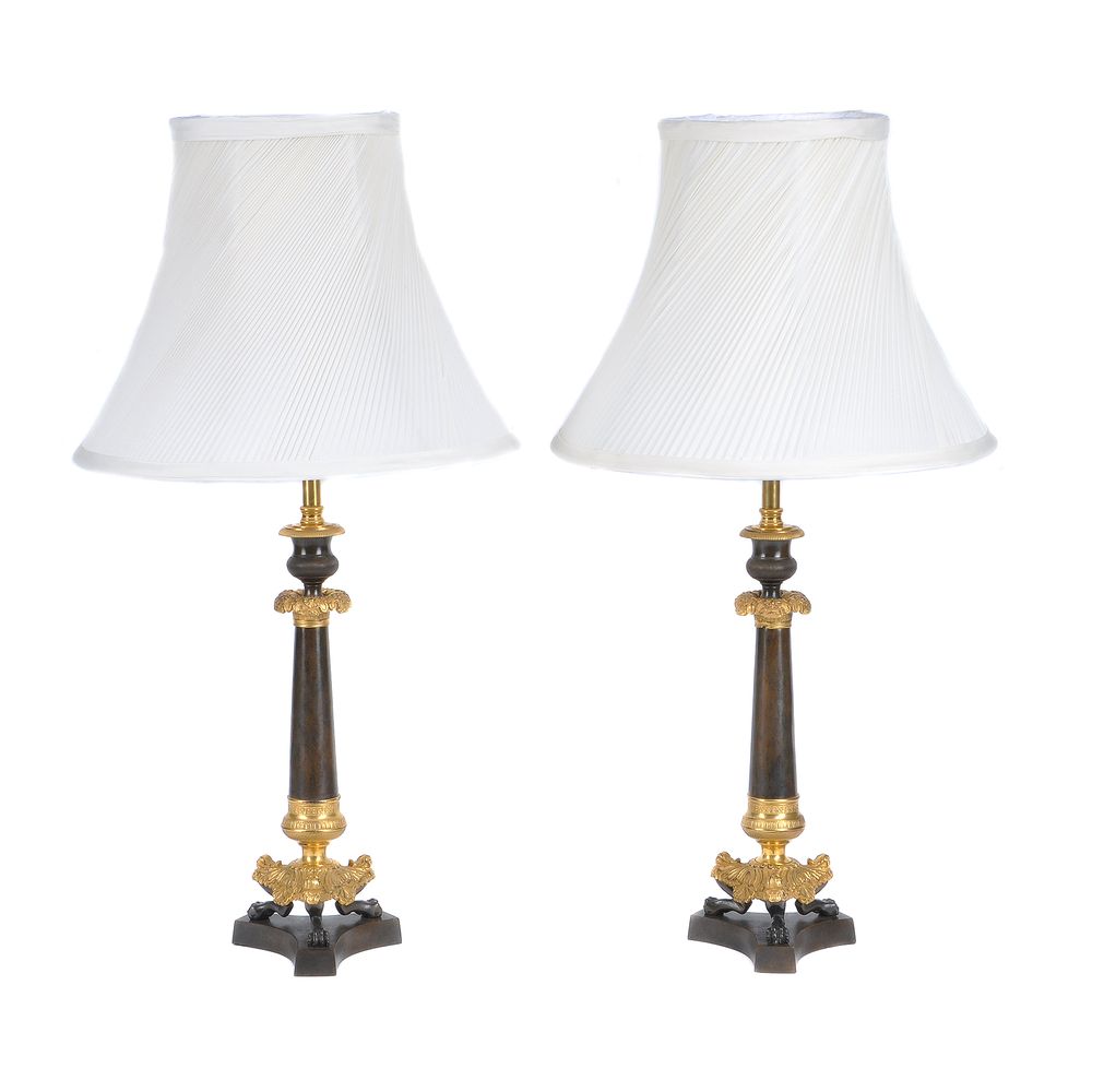 A pair of parcel gilt and lacquered metal table lamps