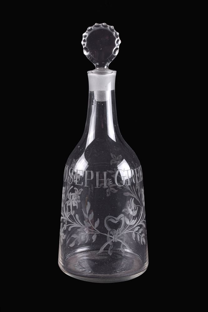 An engraved commemorative mallet-shaped decanter and stopper