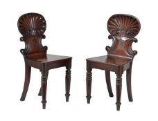 A pair of George IV mahogany hall chairs