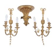 A pair of carved and giltwood twin light wall appliques in 18th century taste