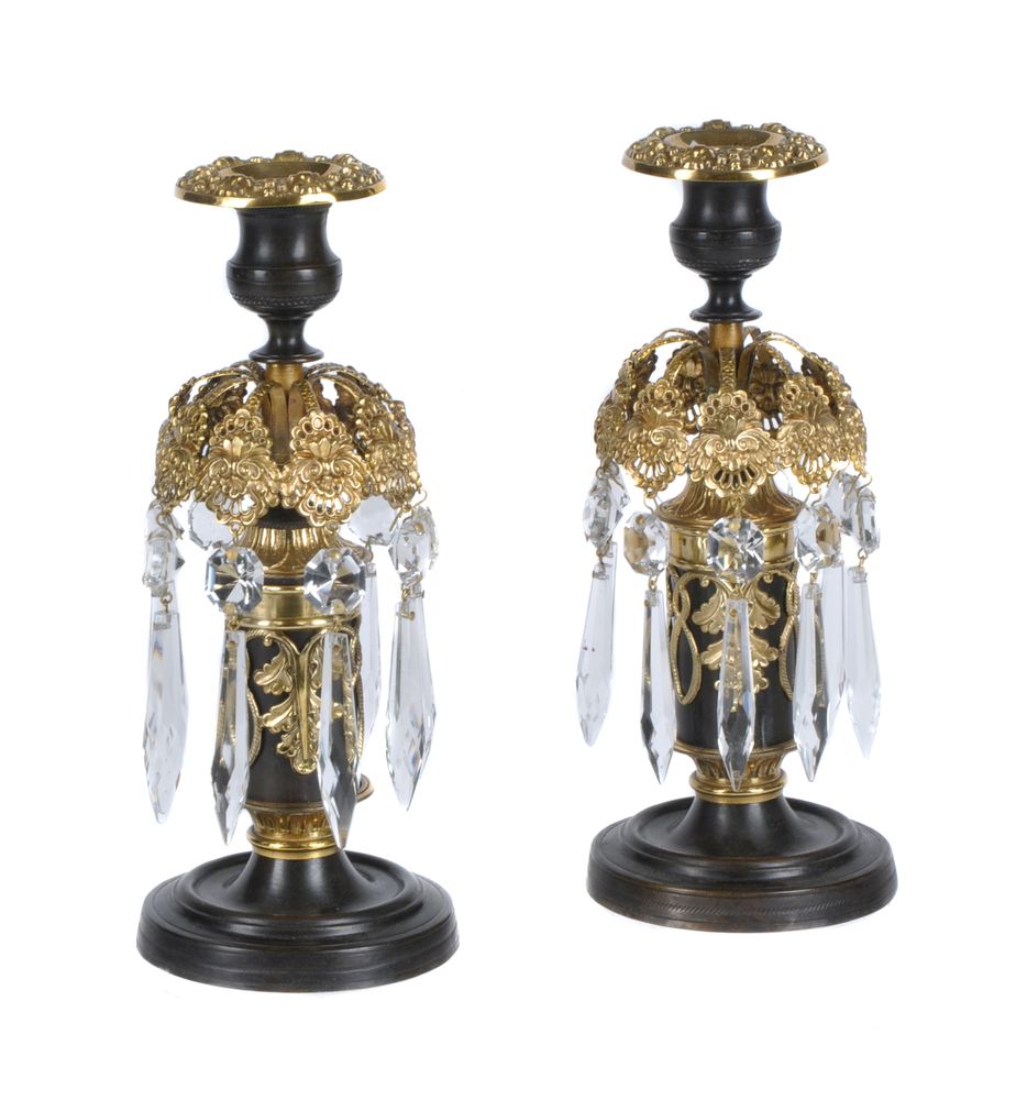 A pair of Regency parcel gilt and lacquered brass and cut glass lustre candlesticks