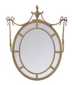 A painted and parcel gilt composition wall mirror in George III Adam style