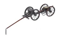 A brass and iron mounted stained wood model of a field cannon and limber