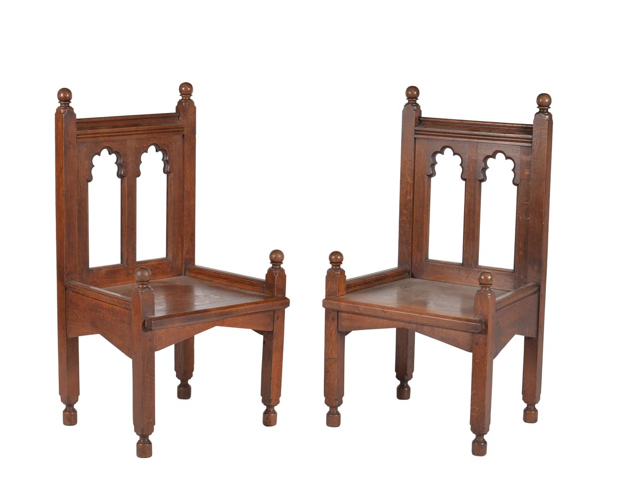 A pair of oak Gothic revival armchairs