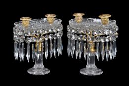 A pair of Regency cut glass and gilt bronze mounted twin light lustre candelabra