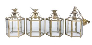 A set of four gilt metal and glazed hexagonal hall lanterns