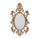 A carved gilt framed oval wall mirror in George III style