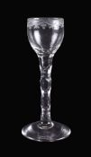 An engraved facet-stemmed cordial glass