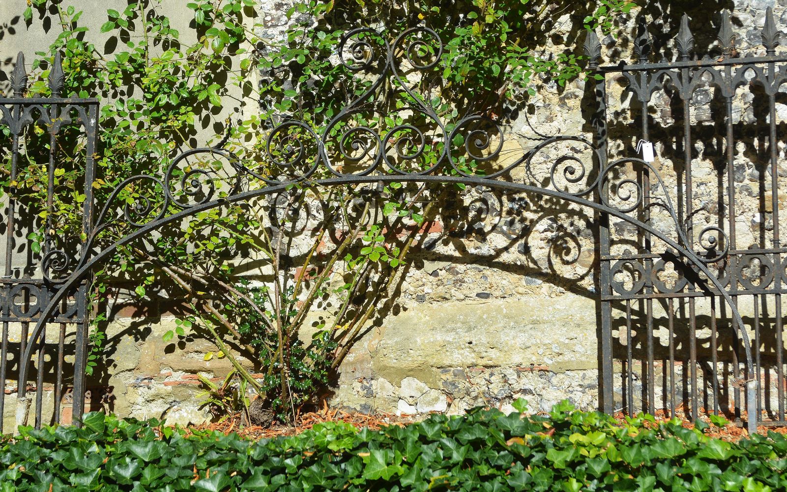 A Gothic Revival wrought iron gate arch