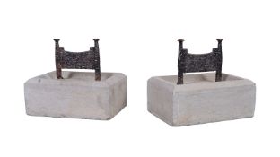 A pair of wrought iron mounted limestone bootscrapes