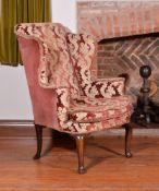 A George II walnut wing armchair