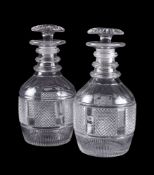 A pair of cut-glass club-shaped decanters and stoppers