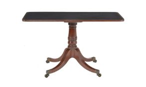 ϒ A simulated rosewood and leather inset centre table