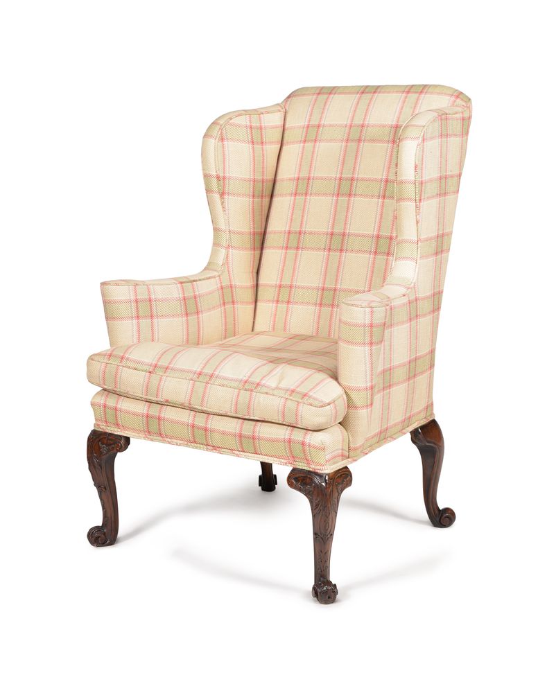 A mahogany and upholstered wing armchair