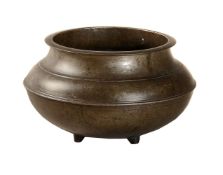 A turned bronze cooking pot