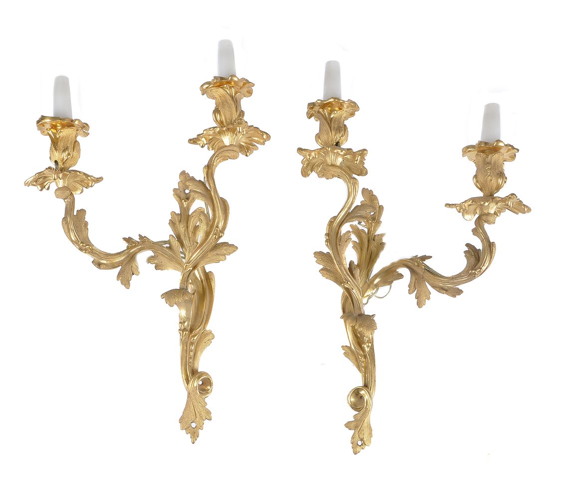 A pair of gilt metal twin light wall appliques in Louis XV style