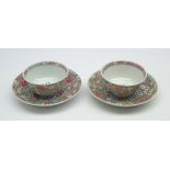 Pair of Chinese Quianlong famille rose tea bowls and saucers decorated with flower heads and