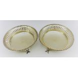 Pair of silver circular sweetmeat dishes with pierced decoration on open work feet and engraved